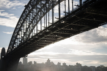 Sydney Harbor Bridge skyline sunrise sky clouds road structure metal strong arch silhouette drive 