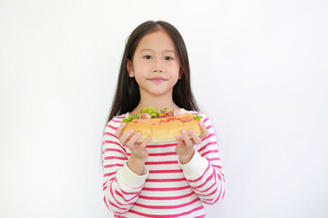 Portrait of Asian little child girl holding HOT DOG for you on white background. Focus at kid face