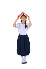 Asian little girl child in Thai school uniform standing with hold open book cover over head isolated on white background. Full length with clipping path