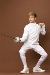 Boy fencer standing in attacking pose