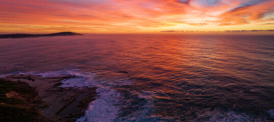Fototapeta na wymiar Aerial Sunrise Seascape Panorama with colourful high cloud
