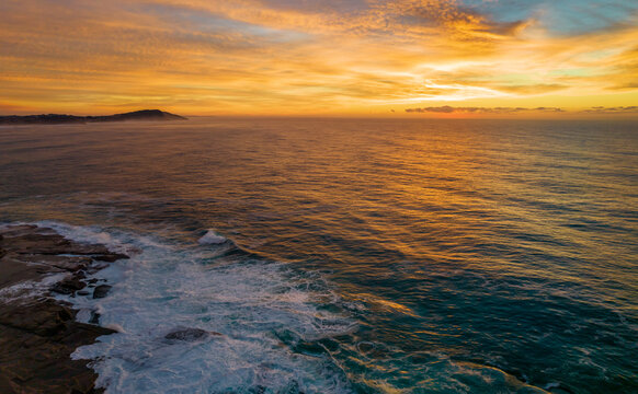 Aerial Sunrise Seascape Panorama at Rocky Inlet with colourful high cloud