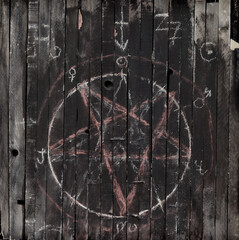 Wooden background with pentagram and mystic symbols.