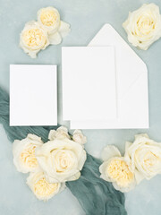 Obraz na płótnie Canvas Blank stationery card on light blue textured background with fresh roses