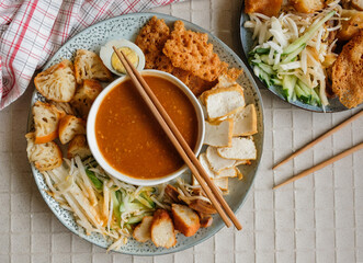 Popular Indian gourmet in Malaysia / Rojak or Pasembur / Fried dough shrimp fritters, tofu, egg, spicy cuttlefish, shredded cucumber, turnip and bean sprouts in thick and spicy peanut gravy sauce