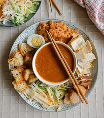 Popular Indian gourmet in Malaysia / Rojak or Pasembur / Fried dough shrimp fritters, tofu, egg, spicy cuttlefish, shredded cucumber, turnip and bean sprouts in thick and spicy peanut gravy sauce
