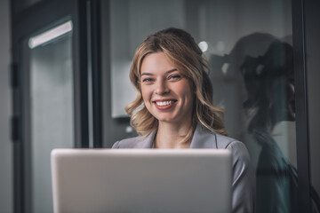 Happy young business woman with laptop