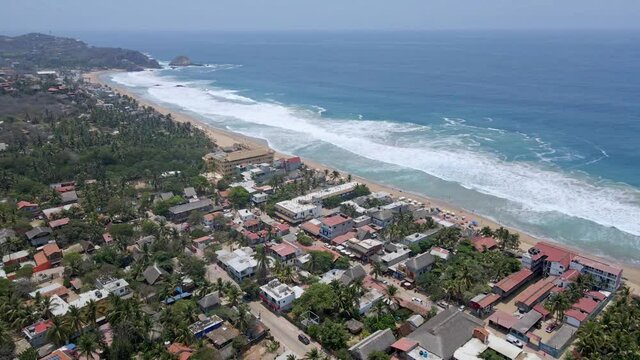 aerial shot waves arriving at zipolite beach in oaxaca