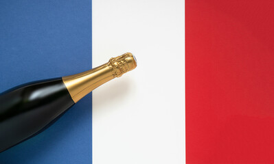 French champagne bottle and national French flag, top view, Bastille Day and French National Day concept