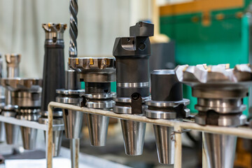 Accessories and tools for a CNC machine on a rack for equipment at a factory and enterprise.