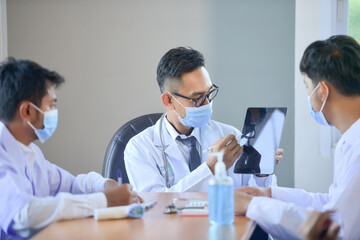 Group of doctors discussing work in office