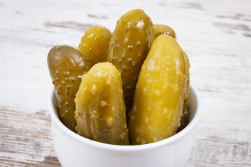 Fresh prepared homemade pickled cucumbers in white bowl, healthy addition to meal