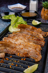 Delicious Grilled Sliced pork belly with barbeque or barbecued sauce plating on plate
