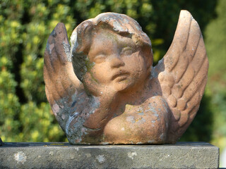 Innocent angel face. Made of stone