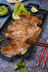 Delicious Grilled Sliced pork belly with barbeque or barbecued sauce plating on plate