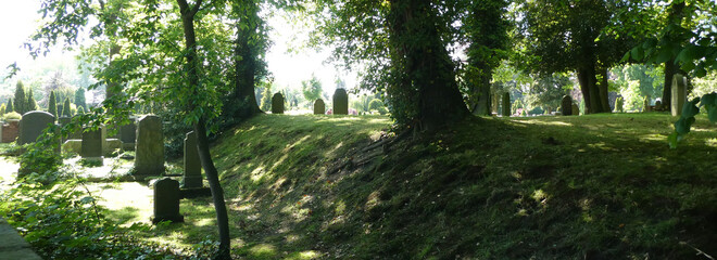 Old very quiet and atmospheric Jewish cemetery. In the background is a Christian graveyard. The oldest grave is from 1771