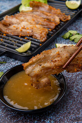 Delicious Grilled Sliced pork belly with barbeque or barbecued sauce plating on plate