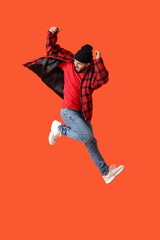 Jumping young man on color background