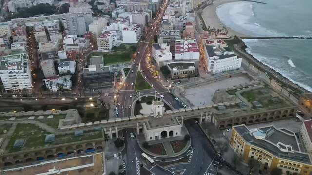 Cinematic View Of Cadiz City. Drone Going forward Passing a large roundabout with cars commuting to work.