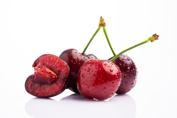 Ripe cherry with water drops on white