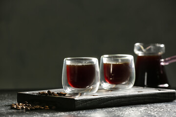 Glass cups of tasty coffee on table
