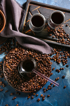 Pot and glass cups of hot coffee on color background © Pixel-Shot