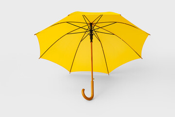 Stylish yellow umbrella on light background
