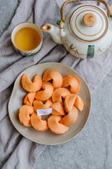 Enjoying snacks with fortune reading / Fortune Cookies / Good and meaningful phrases and proverbs or even printed lucky numbers for lottery - obrazy, fototapety, plakaty