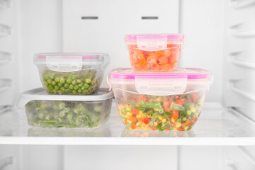 Containers with vegetables in refrigerator