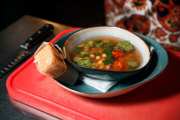 Freshly made aromatic chickpea and meat soup topped with parsley. 