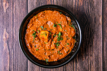 Top shot of Masala Paneer Gravy Indian Cuisine on wooden background