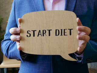  Financial concept meaning START DIET with phrase on the piece of paper.