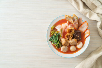 noodles with meatballs in pink soup