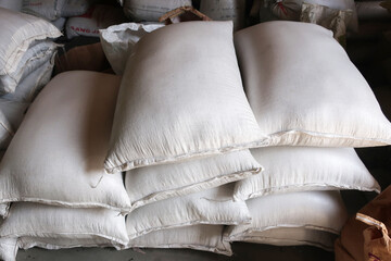 White sacks piled up a little messy, sacks filled with industrial necessities, Surabaya, East Java,...
