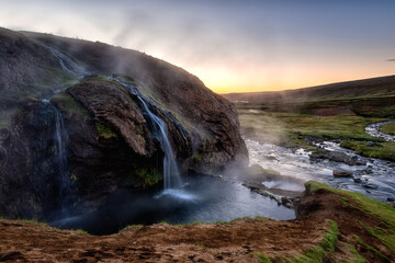 Amazing sunset landscape, scenic view of Laugarvallardalur hot springs, geothermal area with natural hot bath and cool river, outdoor travel background, Iceland