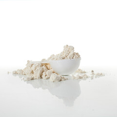 Spoon of protein powder on a white background.
