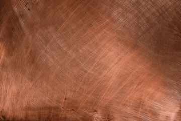 Copper background wonderful reddish-golden color. Light reflection. Chaotic scratches.