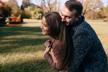 Fototapeta premium A couple in love hugging in the park
