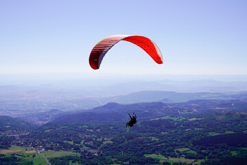 parachute paragliding in sky Puy de Dome blue sky in French Massif Central France
