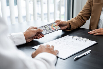 Businessmen give money to bribe partner secretly passing money, bribery and corruption concepts.