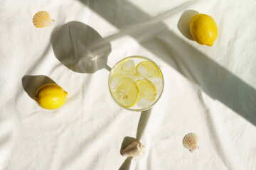 Cocktail or water with lemon and sun shadow.