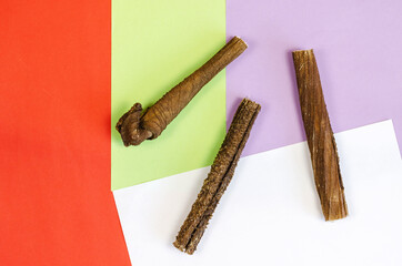 Marketing and advertising of animal products concept. Dog treats on a colorful background. Dried beef stomach sticks. Naturally dried goodies for dogs. Pet.