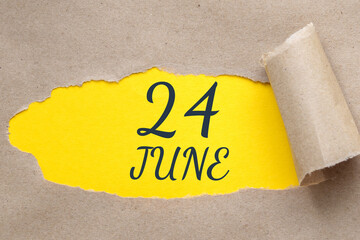 june 24. 24th day of the month, calendar date.Hole in paper with edges torn off. Yellow background is visible through ragged hole.Summer month, day of the year concept