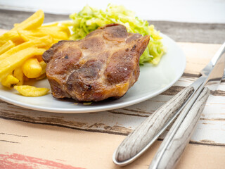 pork steak and french fries with cabbage salad