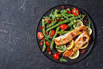 grilled salmon fillets with lemon, bacon,vegetables