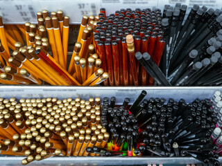 Simple pencils and colored markers are placed on store shelves. The concept of sales through a...