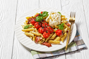 Pasta of penne, bacon, tomatoes, and mozzarella