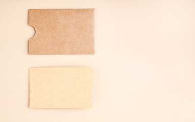 Stylish branding mockup for displaying your artwork, business cards on craft paper. Recyclable material concept, eco-friendly manufacturing. Flat top view. High quality photo