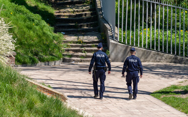 A pair of policemen on patrol in the park