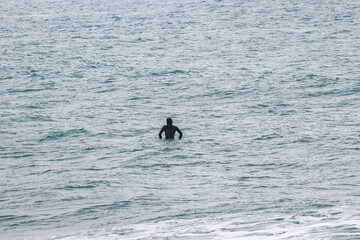 Fototapeta premium Surfer on waiting for a wave in a Surf spot . Surf spot in Ericeira Portugal.